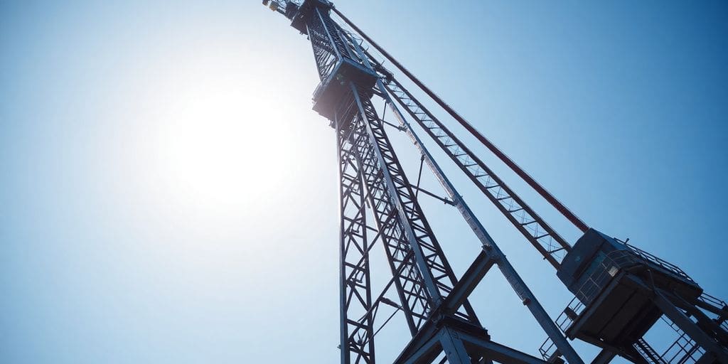 Crane boom against a clear sky.